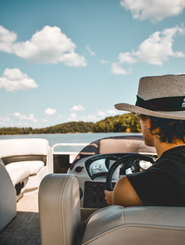 Driver's view from a pontoon boat cruising a wooded inland lake