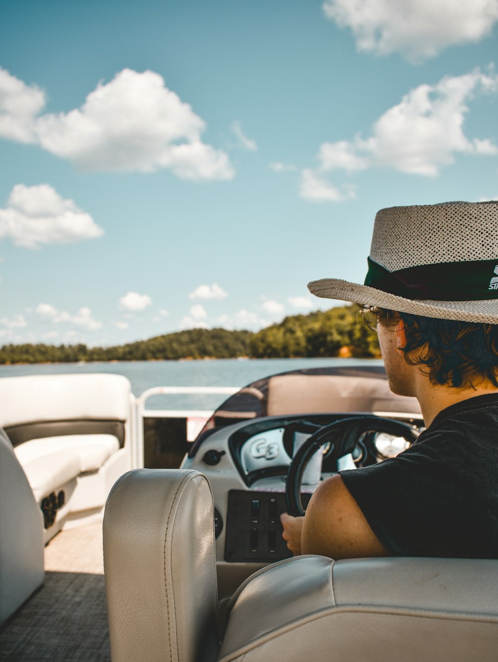 a man driving a boat on a body of water