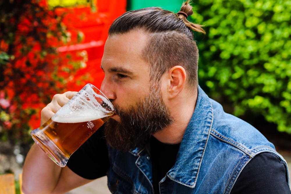 a man with a mohawk drinking a beer