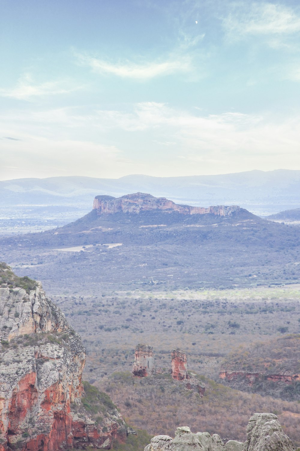 a man sitting on top of a rock formation