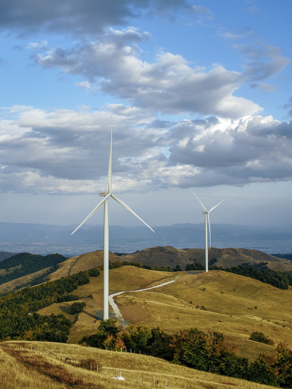 a couple of windmills that are on a hill