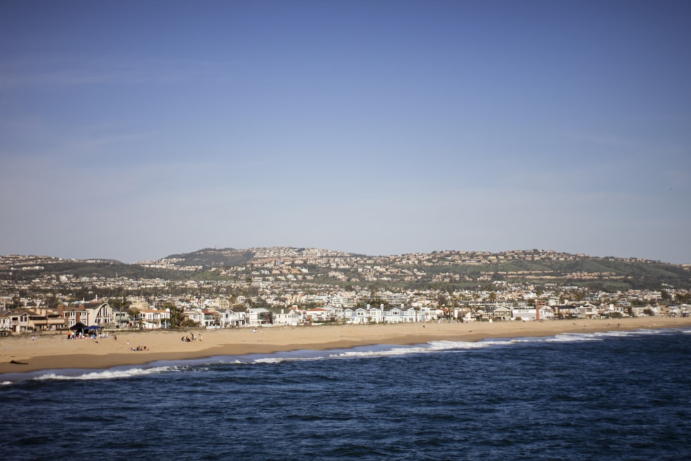 a view of a beach with a city in the background