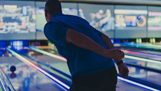a man is bowling down a bowling alley