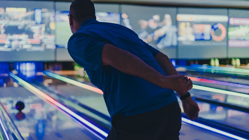 a man is bowling down a bowling alley