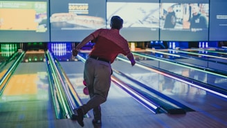 a man is bowling down a bowling alley