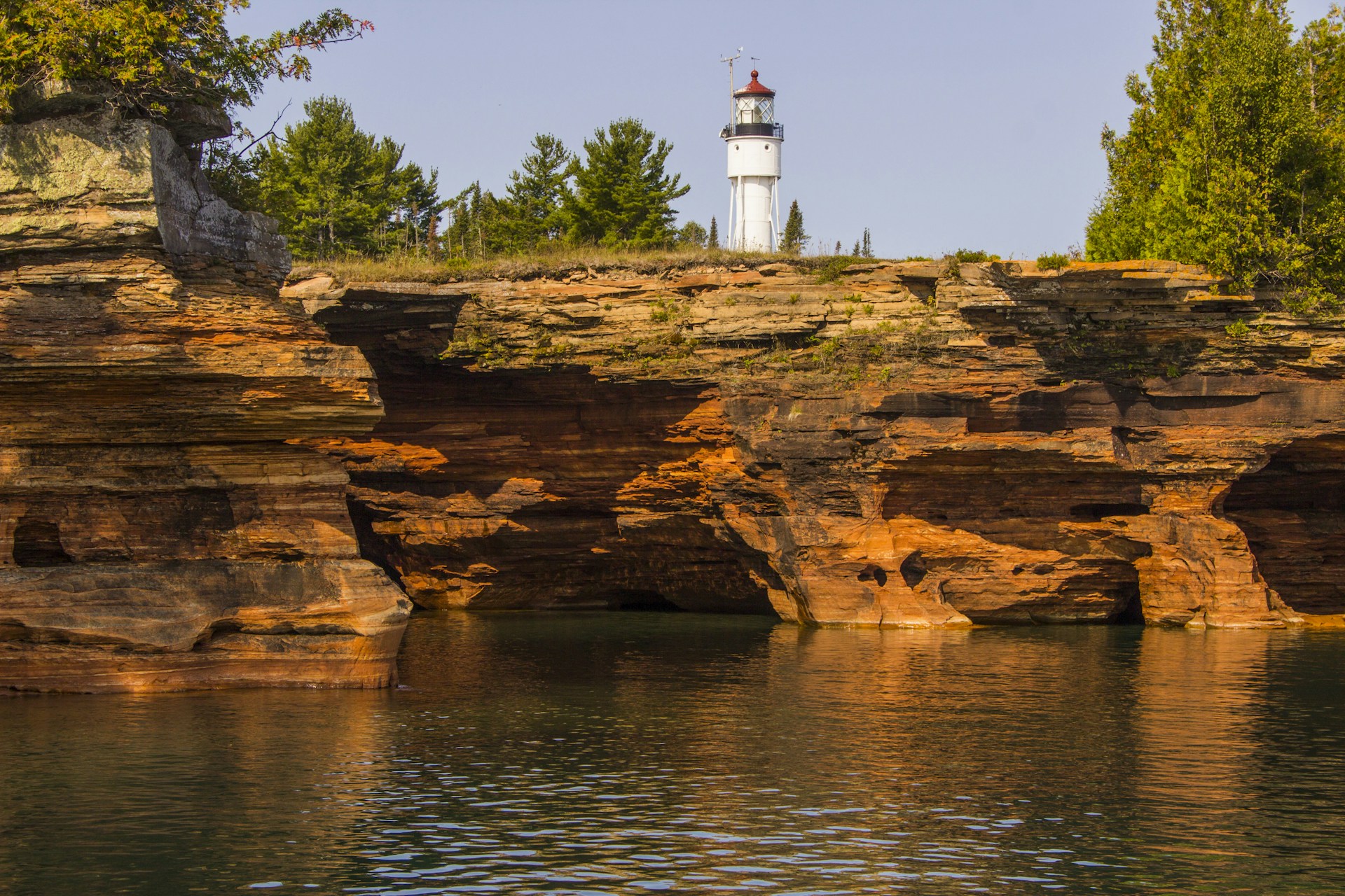 a lighthouse on a cliff above a body of water