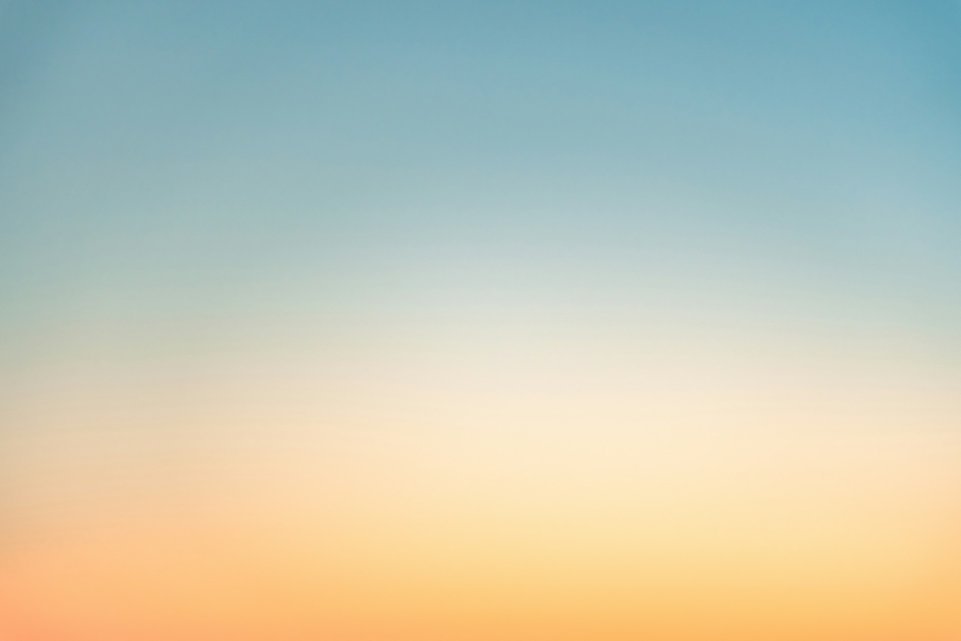 a blurry photo of a beach with a boat in the water