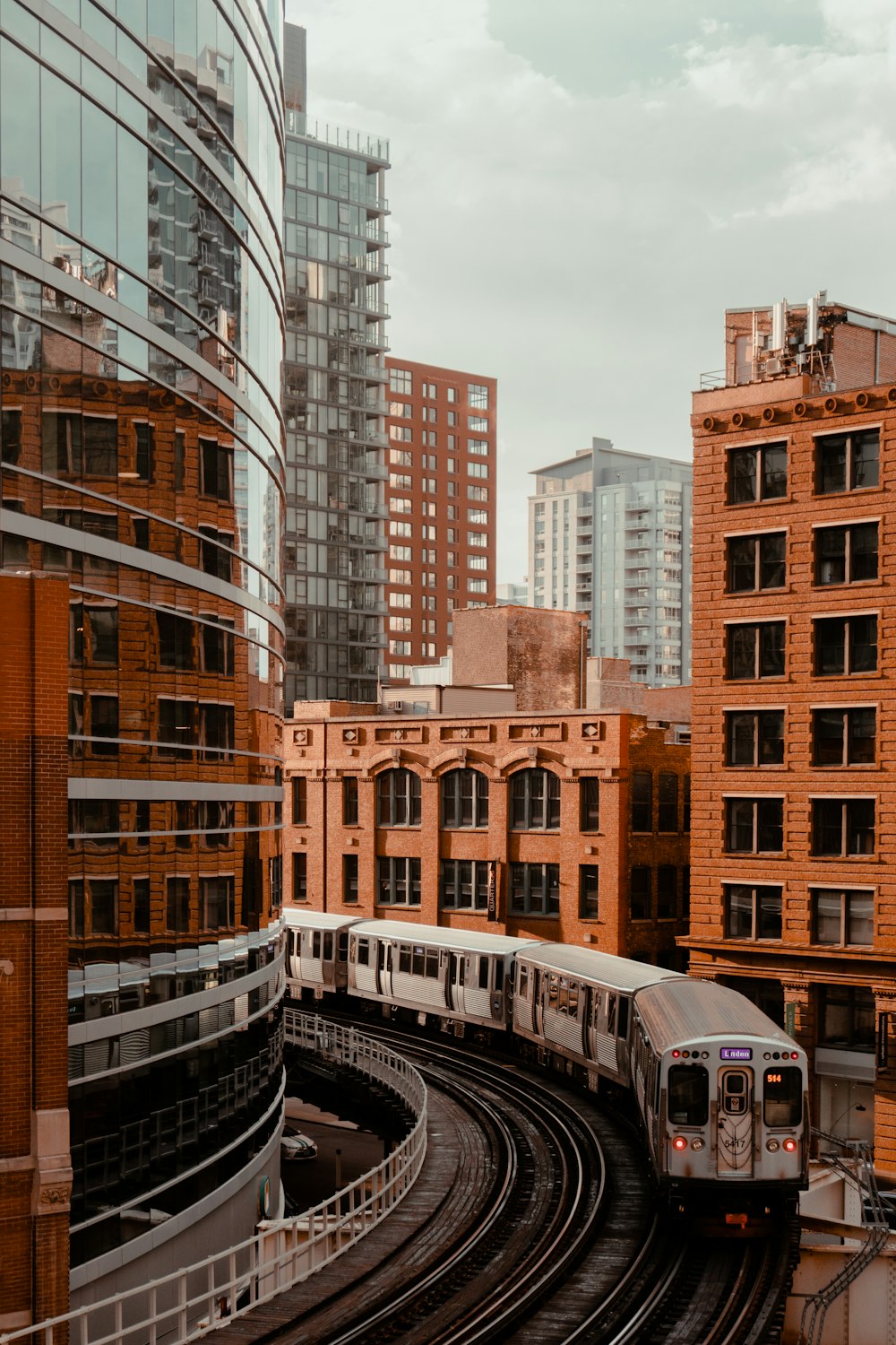 a train traveling through a city next to tall buildings