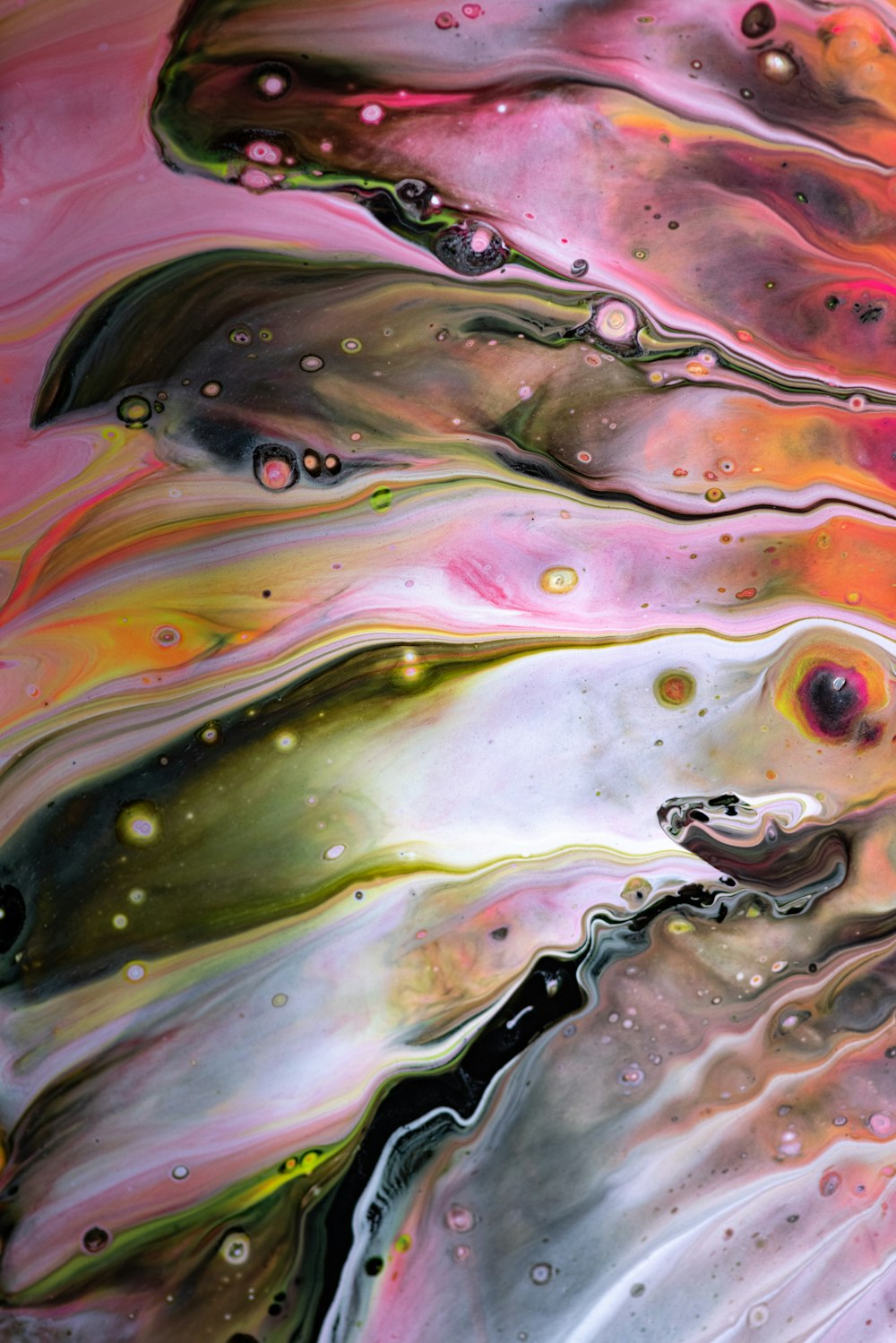a close up of a liquid painting on a surface