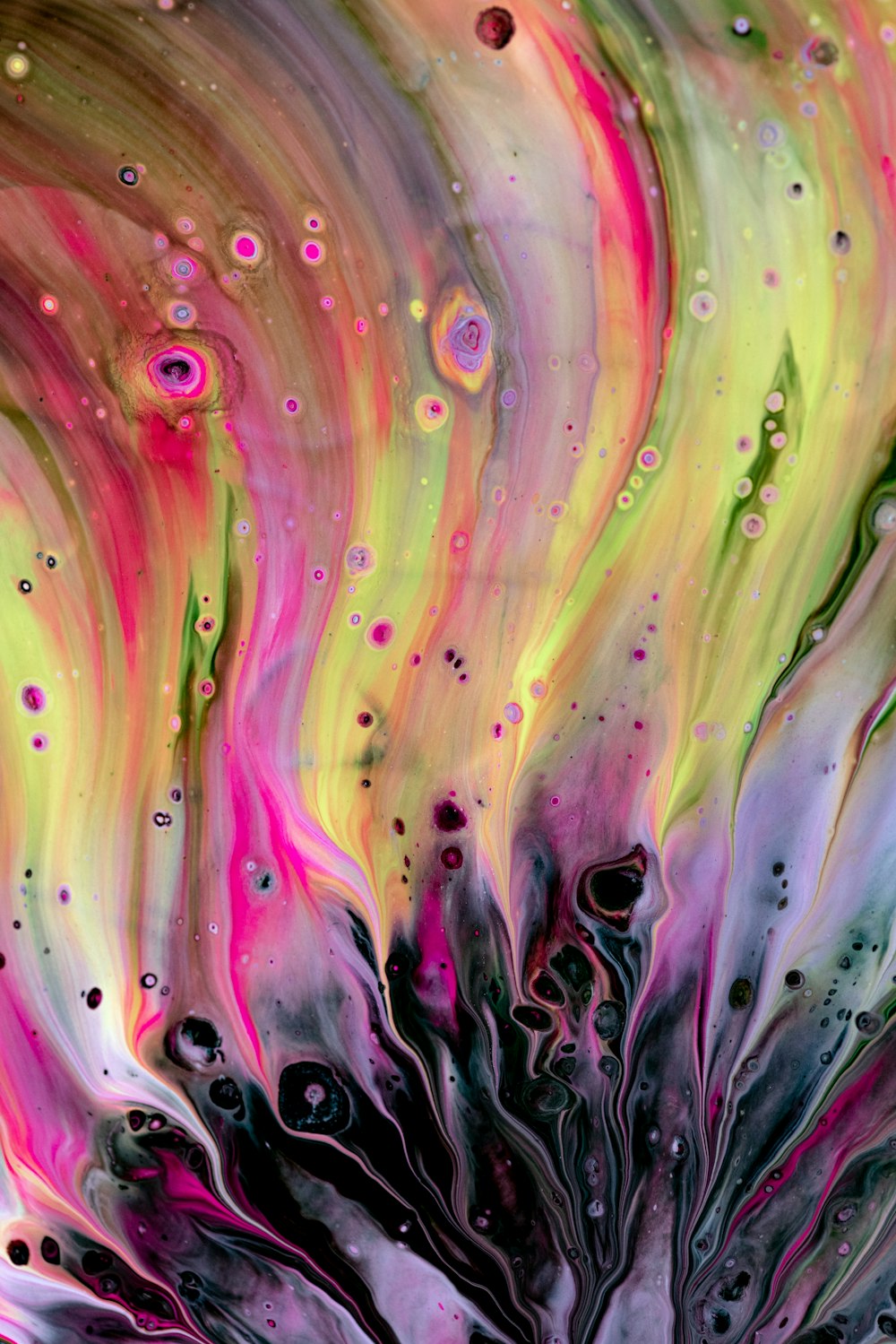 a close up of a colorful liquid painting