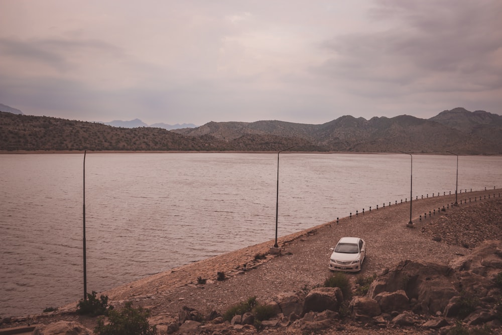 a car parked on the side of a lake