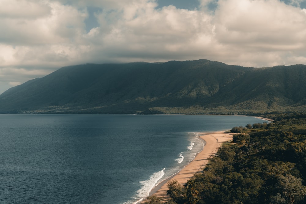 a scenic view of a beach and mountains