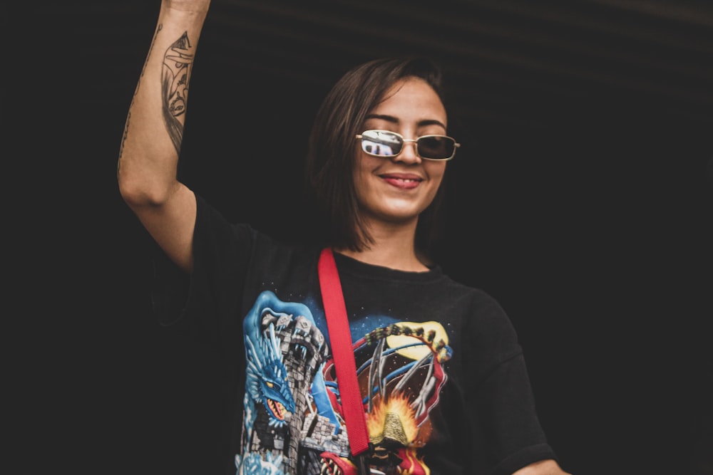 a woman wearing a black shirt and a red bag