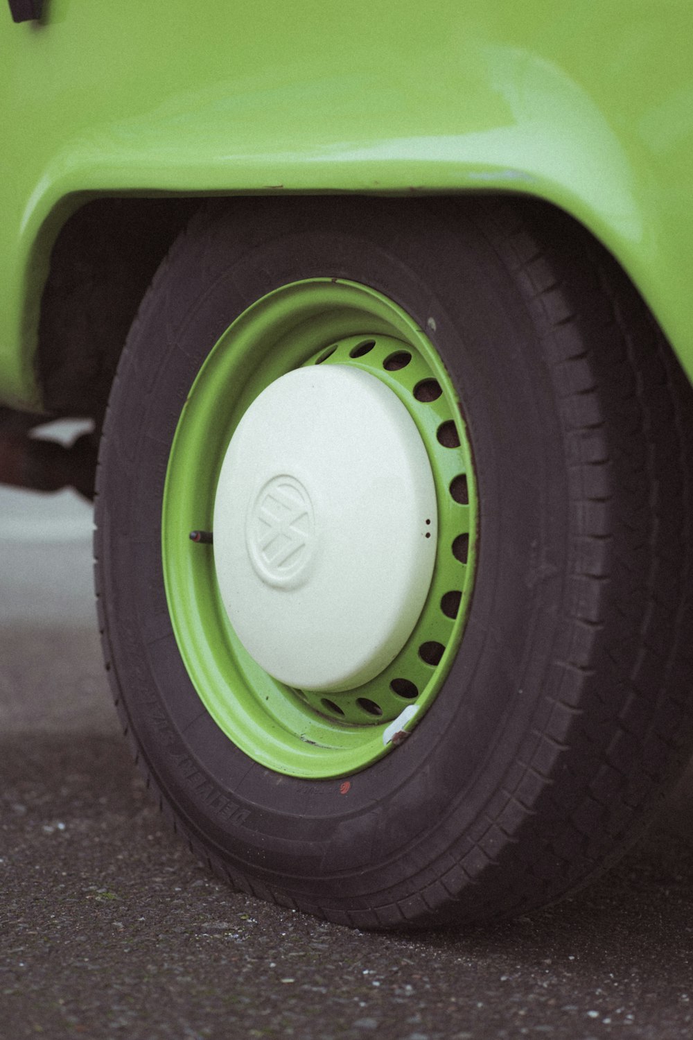 a close up of a tire on a green car