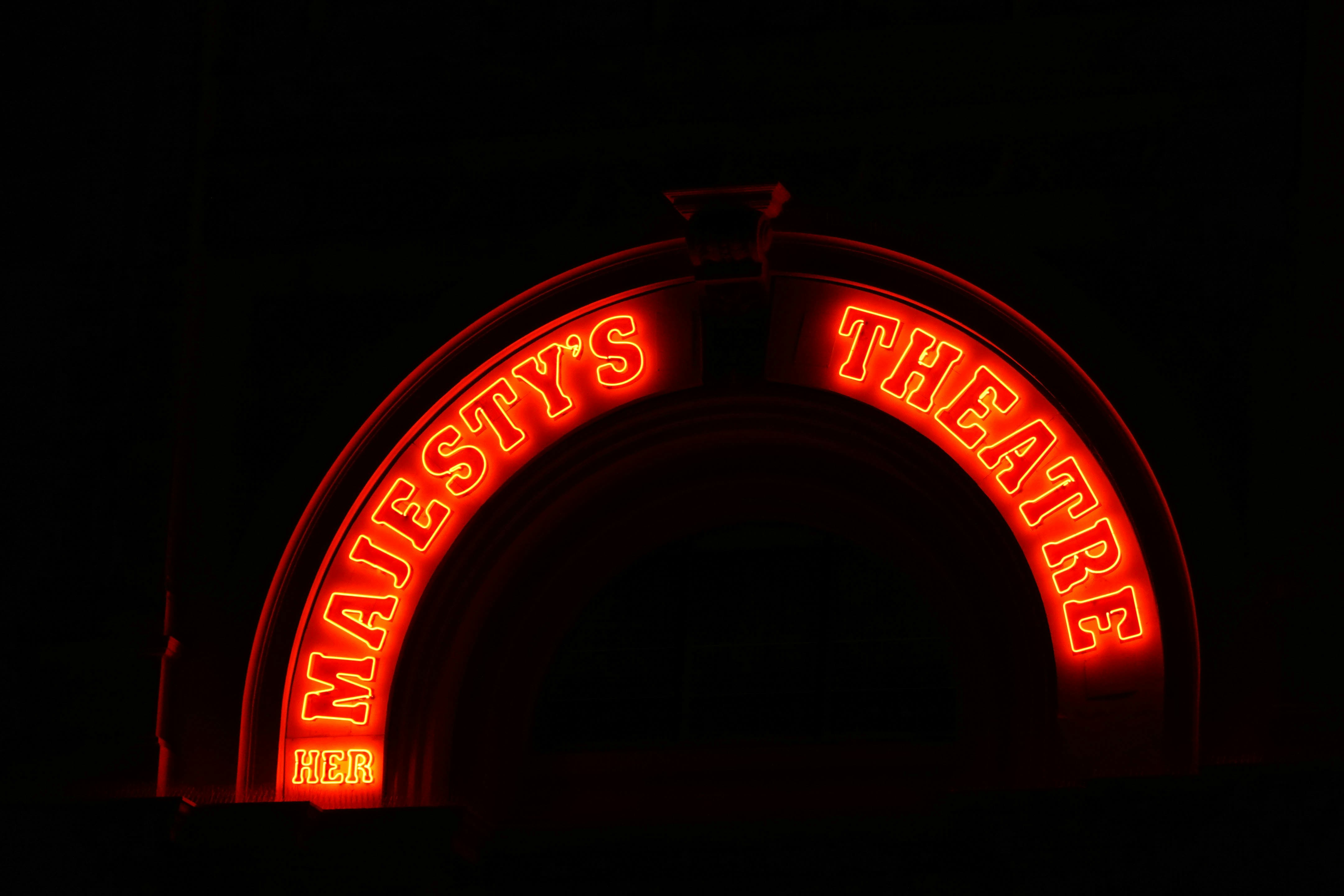 Neon theatre sign at night