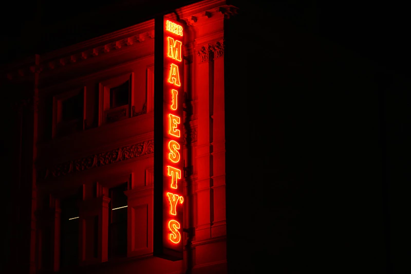 red neon sign on a city building