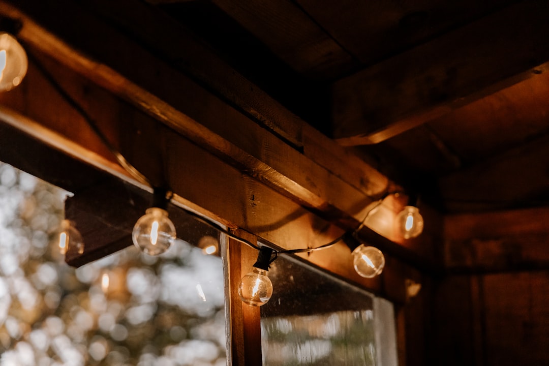 a group of lights hanging from a wooden ceiling, Rustic mood