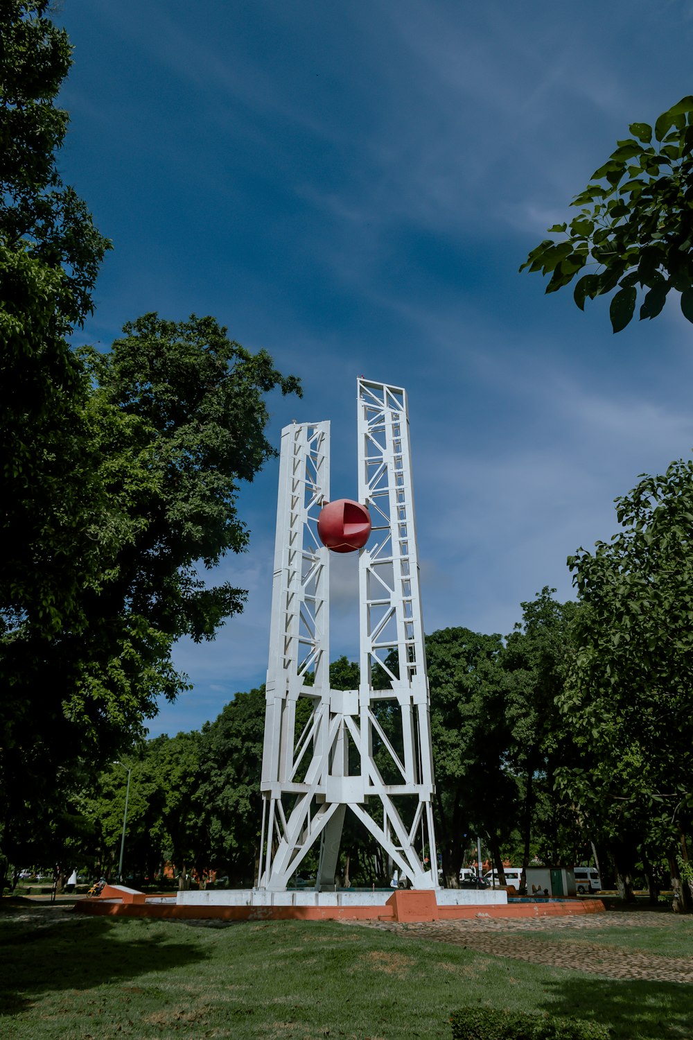 a tall white structure with a red ball on top of it