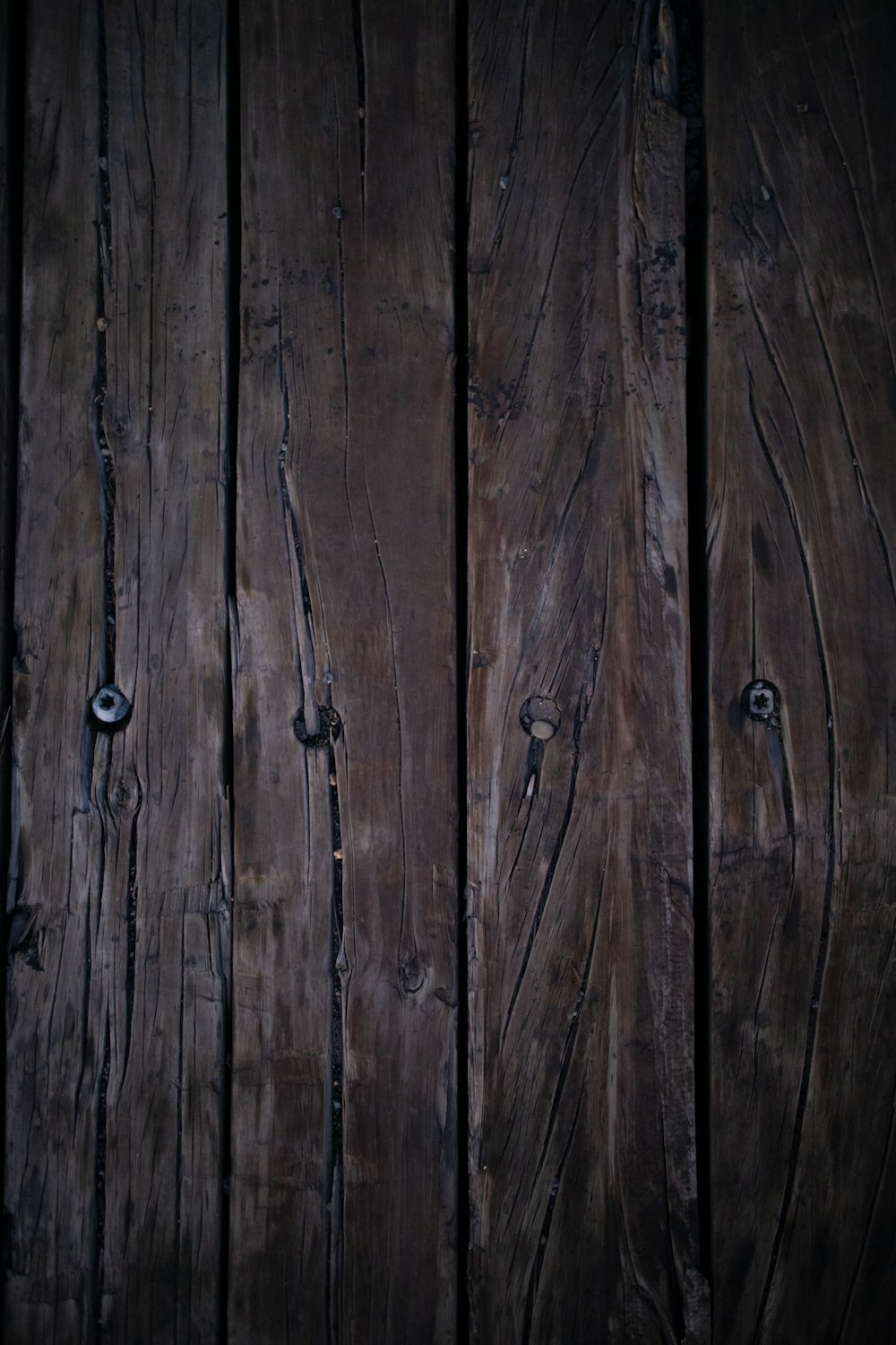 a close up of a wooden wall with nails