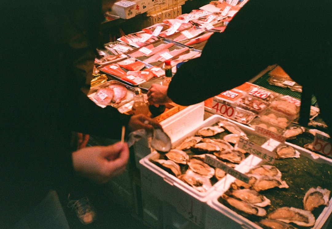 a man standing in front of a table filled with food,
