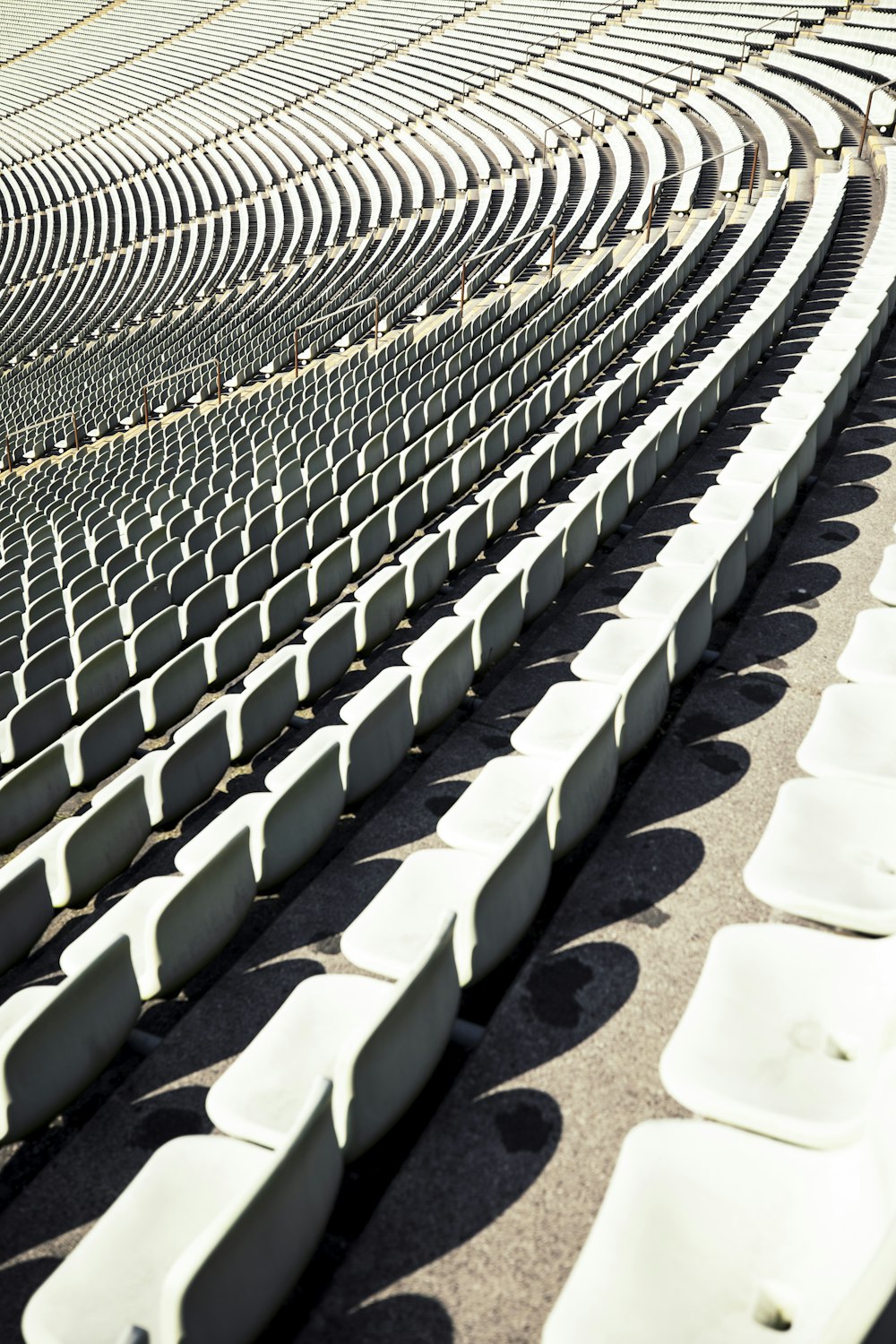 rows of white seats in a stadium or arena