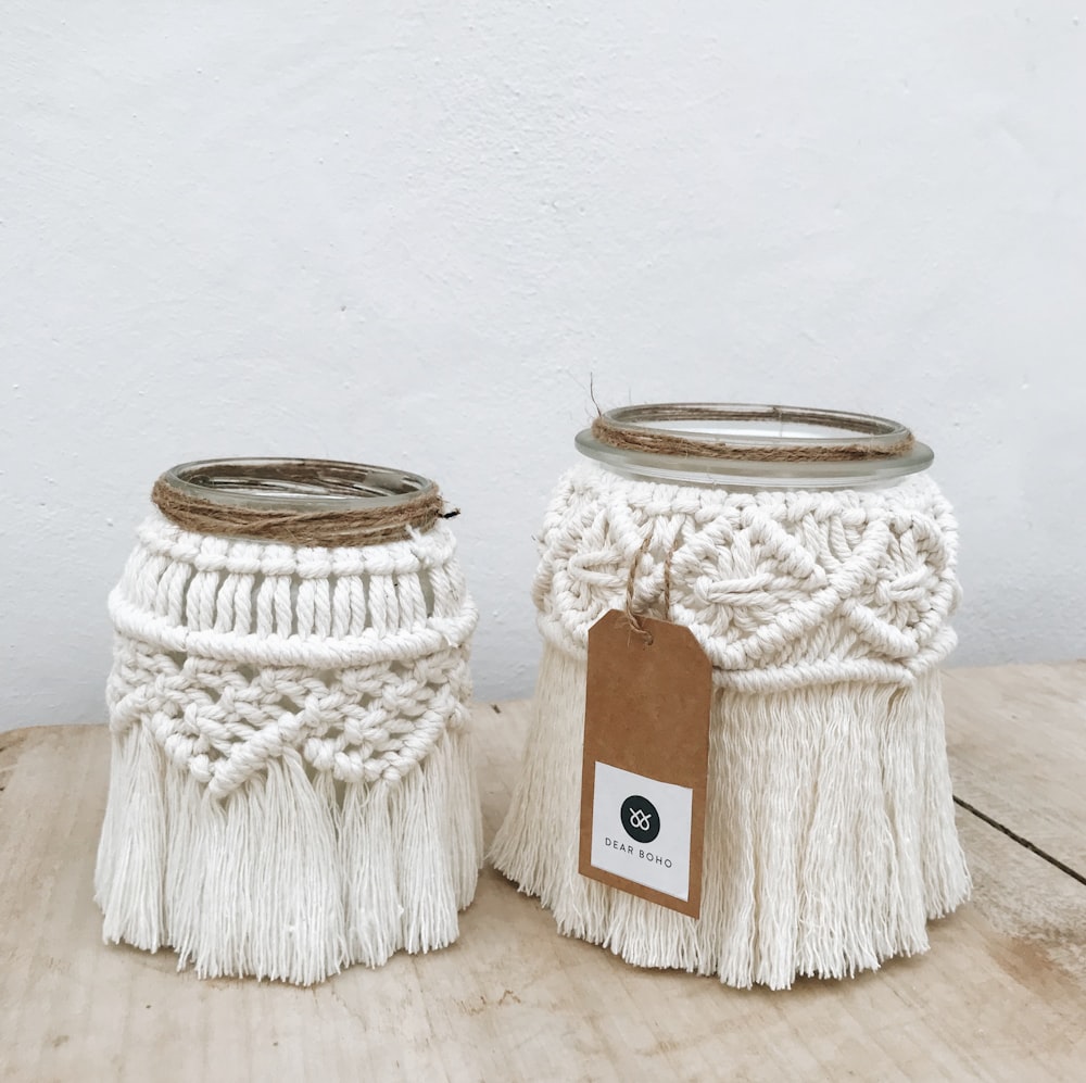 a couple of jars sitting on top of a wooden table