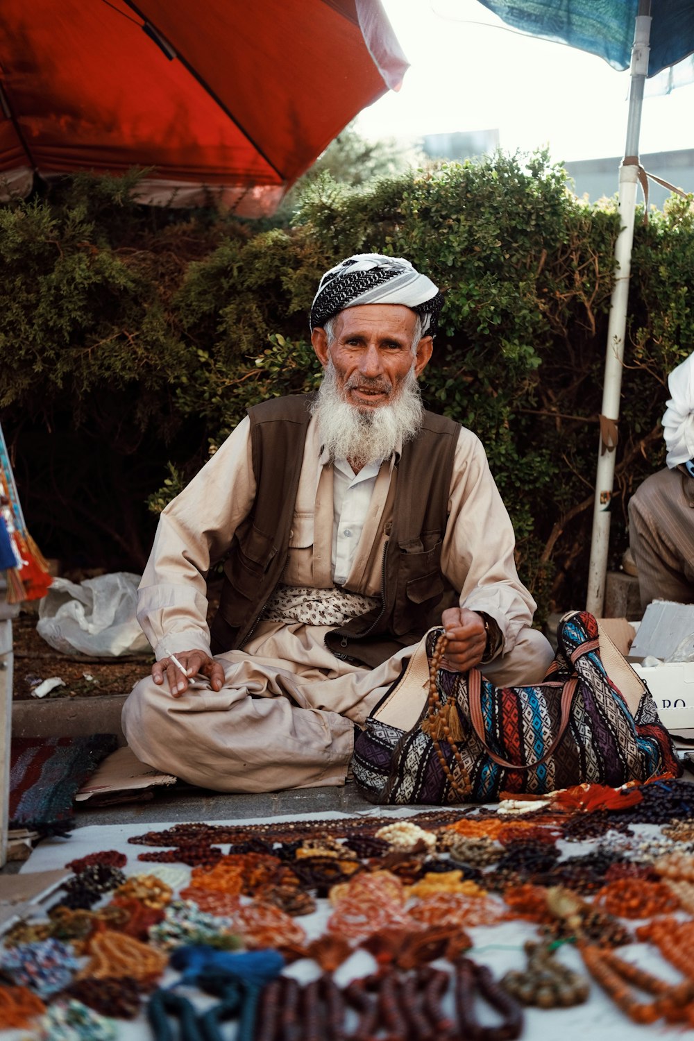 a man sitting in front of a table filled with assorted items