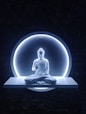a buddha statue sitting in front of a blue light