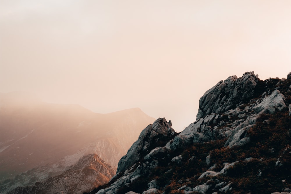 a person standing on top of a rocky mountain