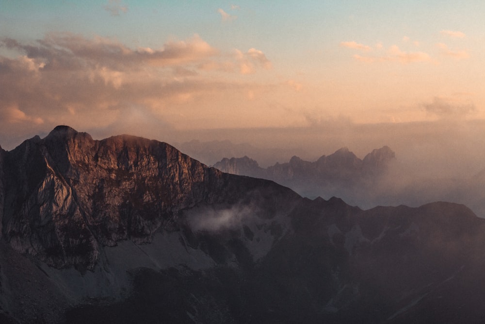 a view of the top of a mountain at sunset