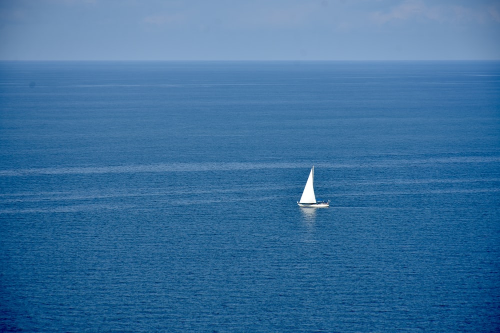 a sailboat in the middle of the ocean