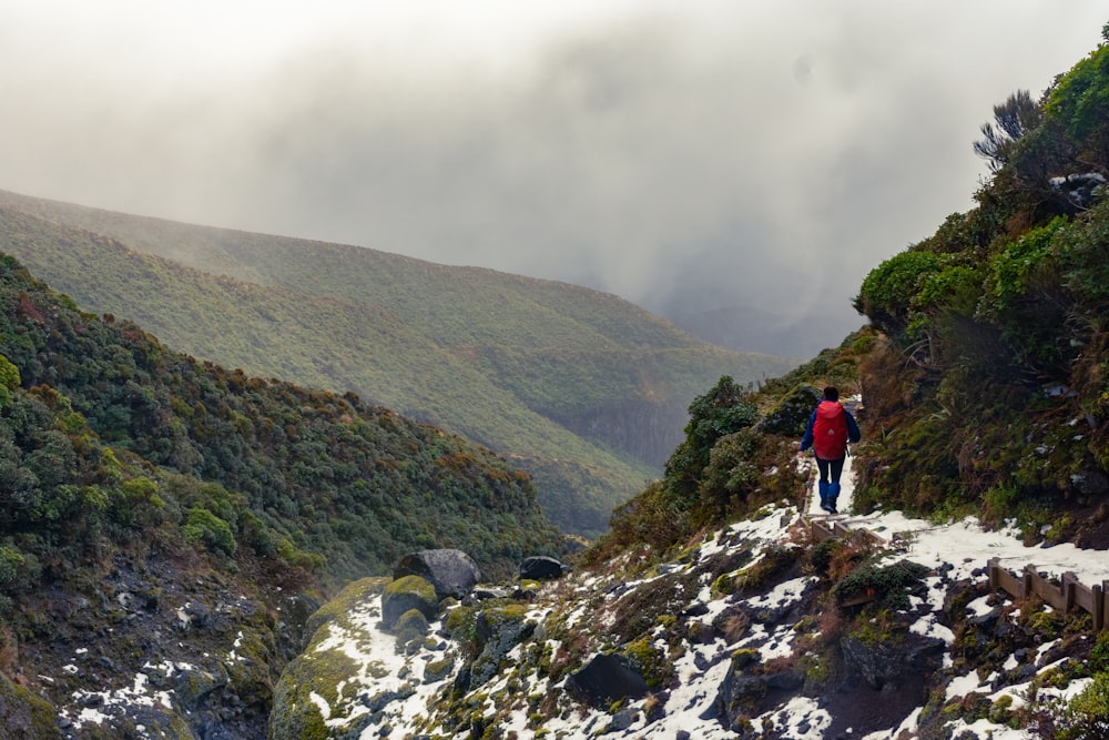 a couple of people standing on top of a snow covered mountain