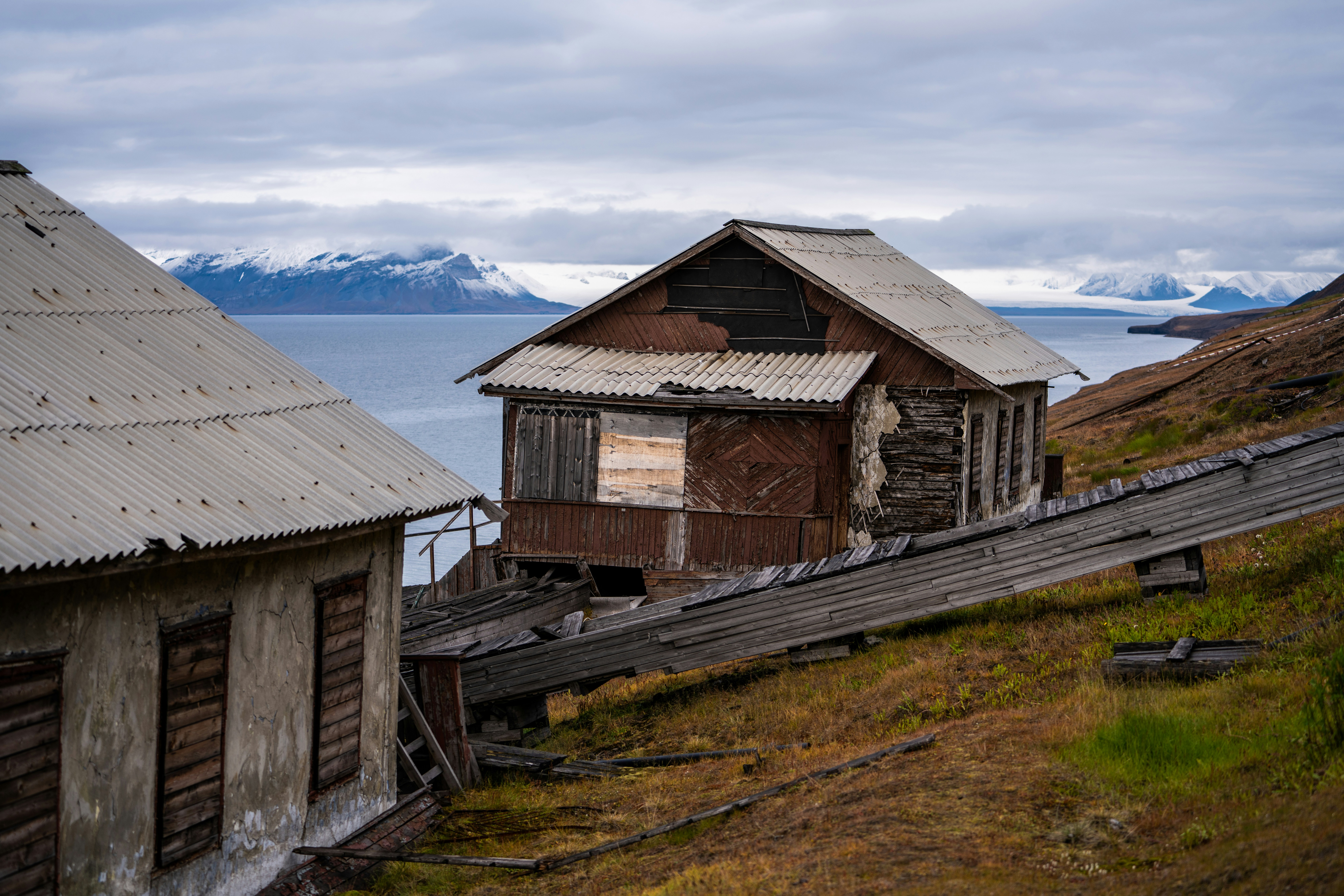 a couple of buildings sitting on the side of a hill