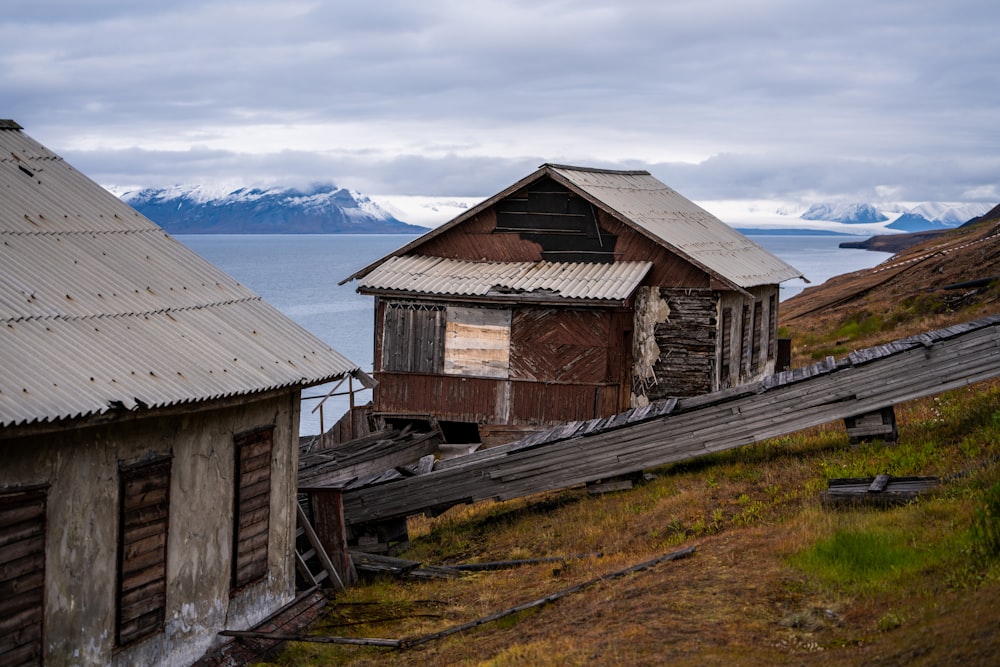 a couple of buildings sitting on the side of a hill