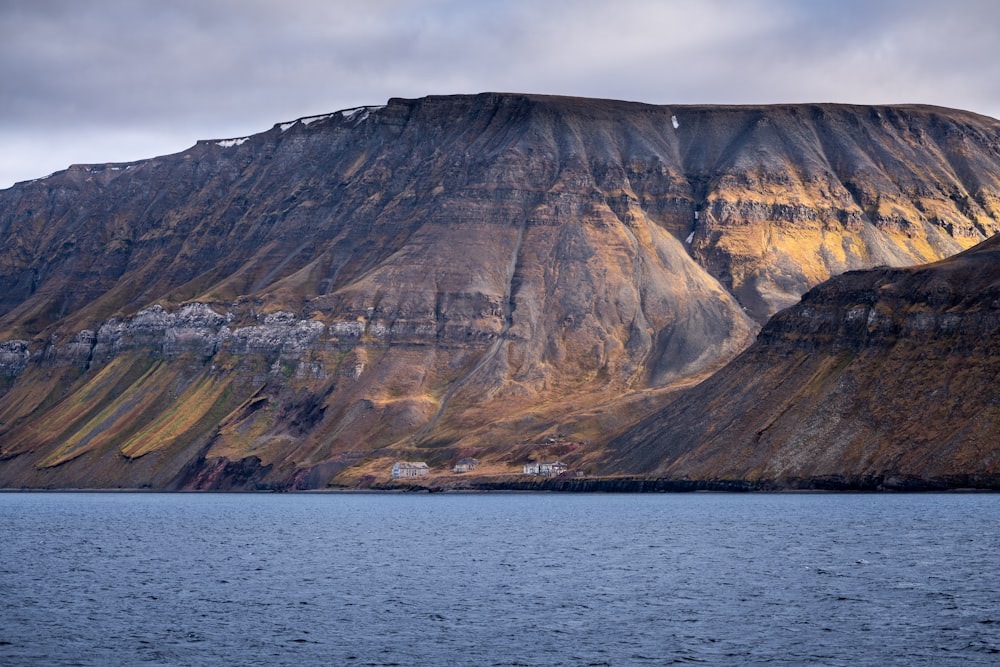 a large mountain with a house on top of it