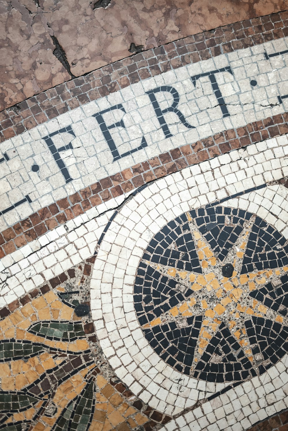 a close up of a tiled floor with a sign on it