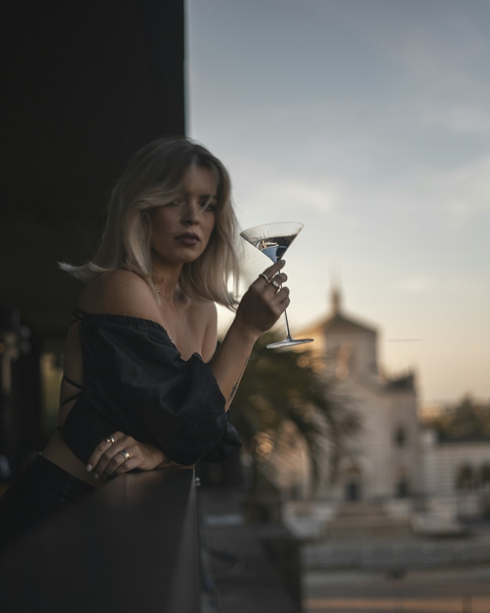 a woman holding a wine glass in her hand