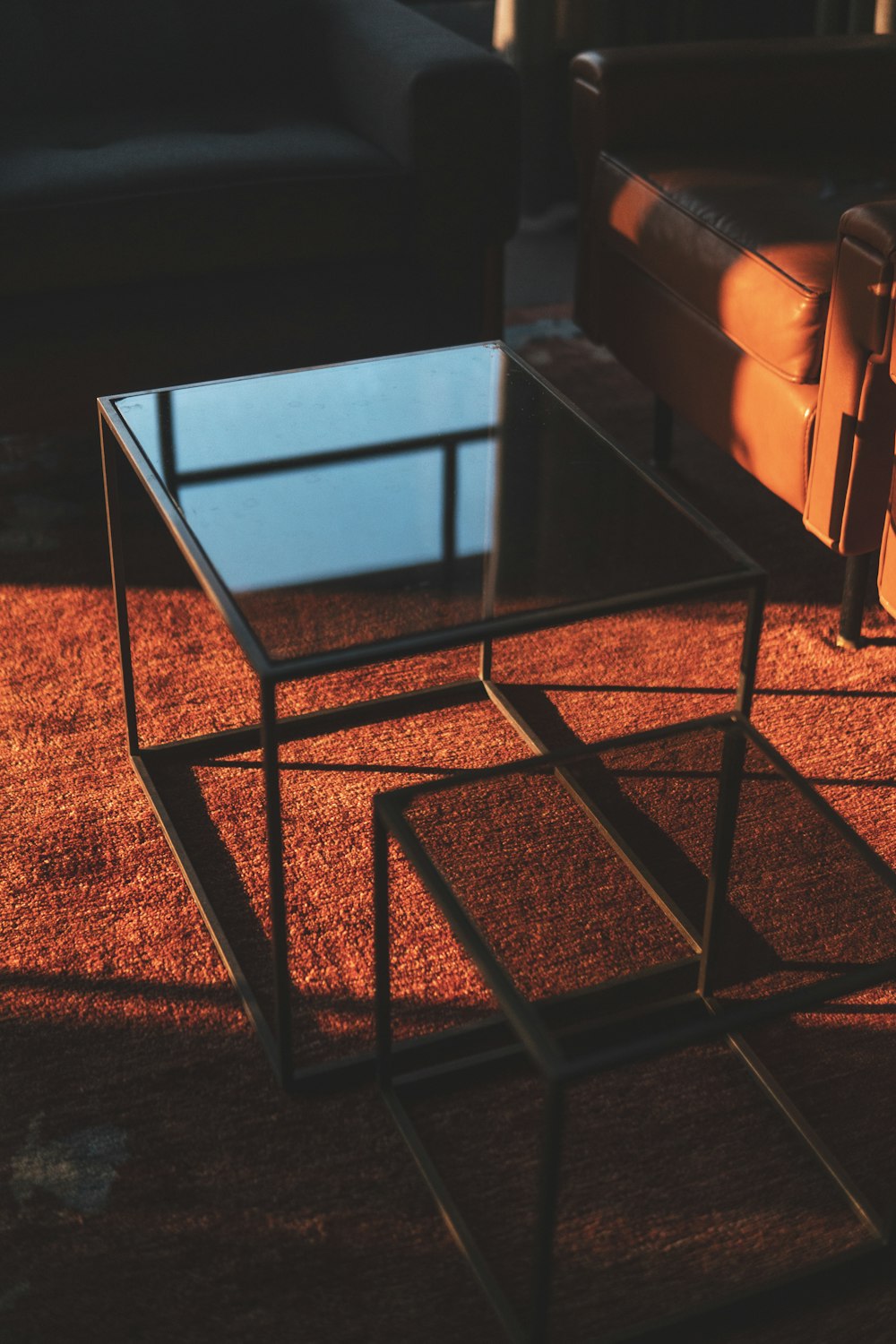 a glass table sitting on top of a brown rug