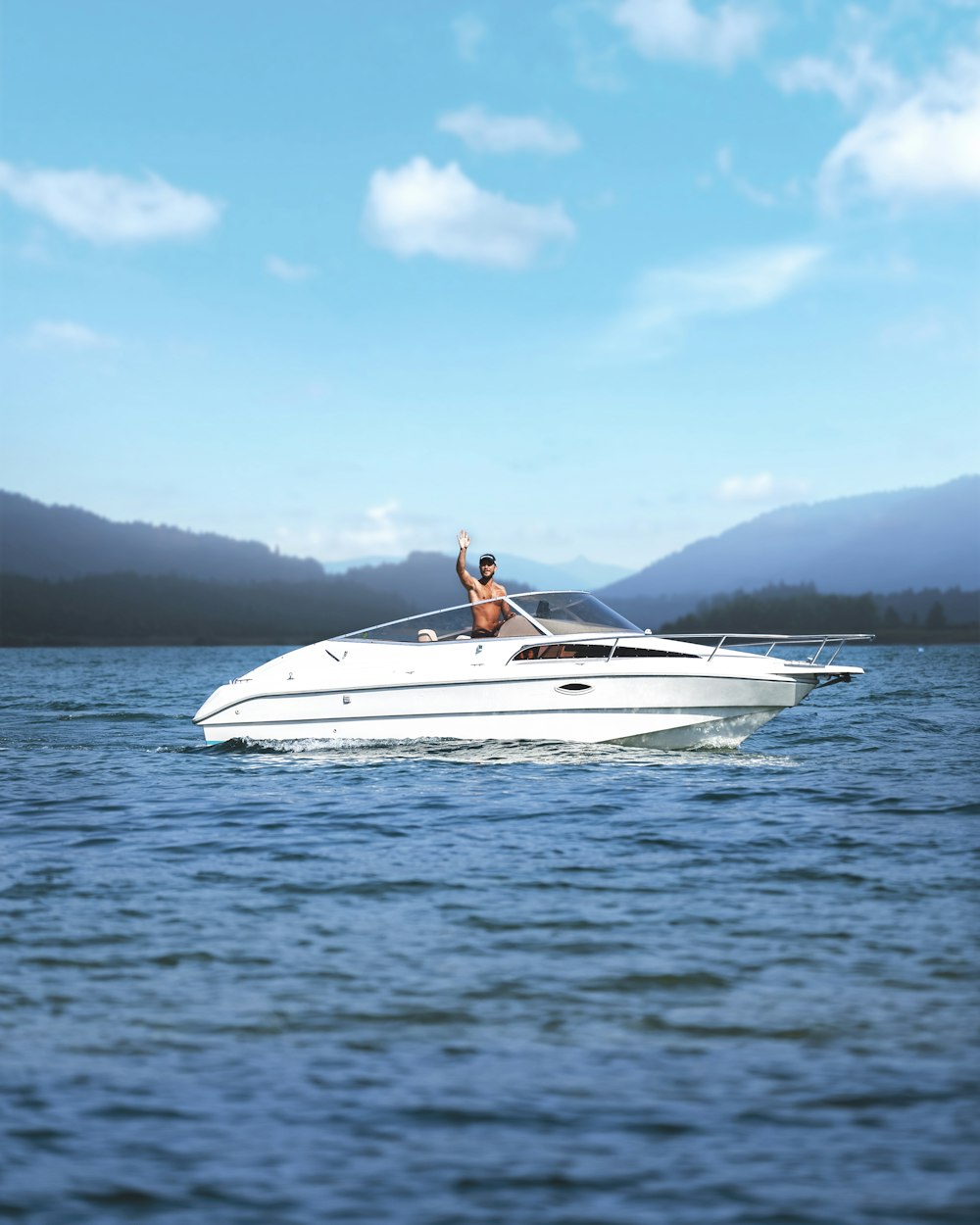 a woman riding on the back of a white boat