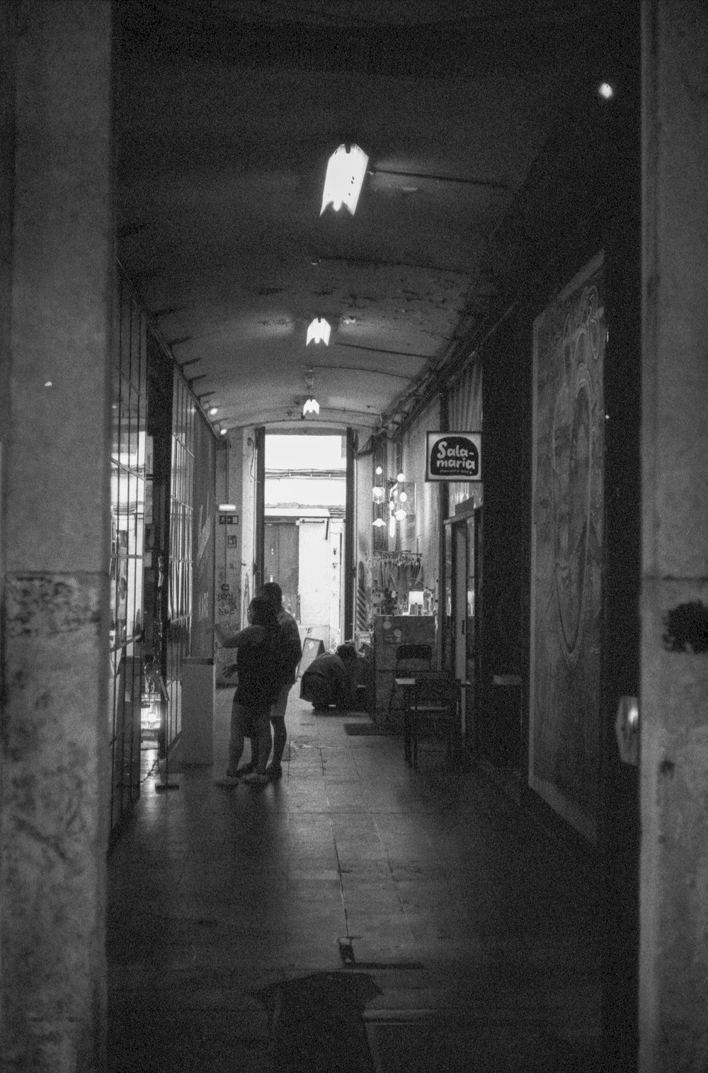 a couple of people that are standing in a hallway