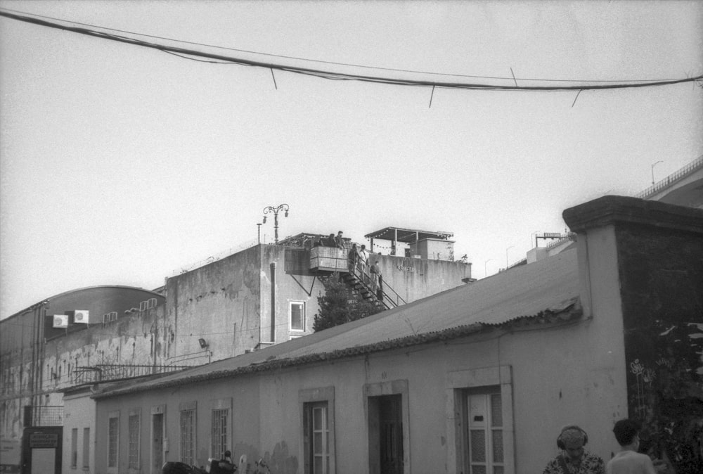 a black and white photo of people walking down a street