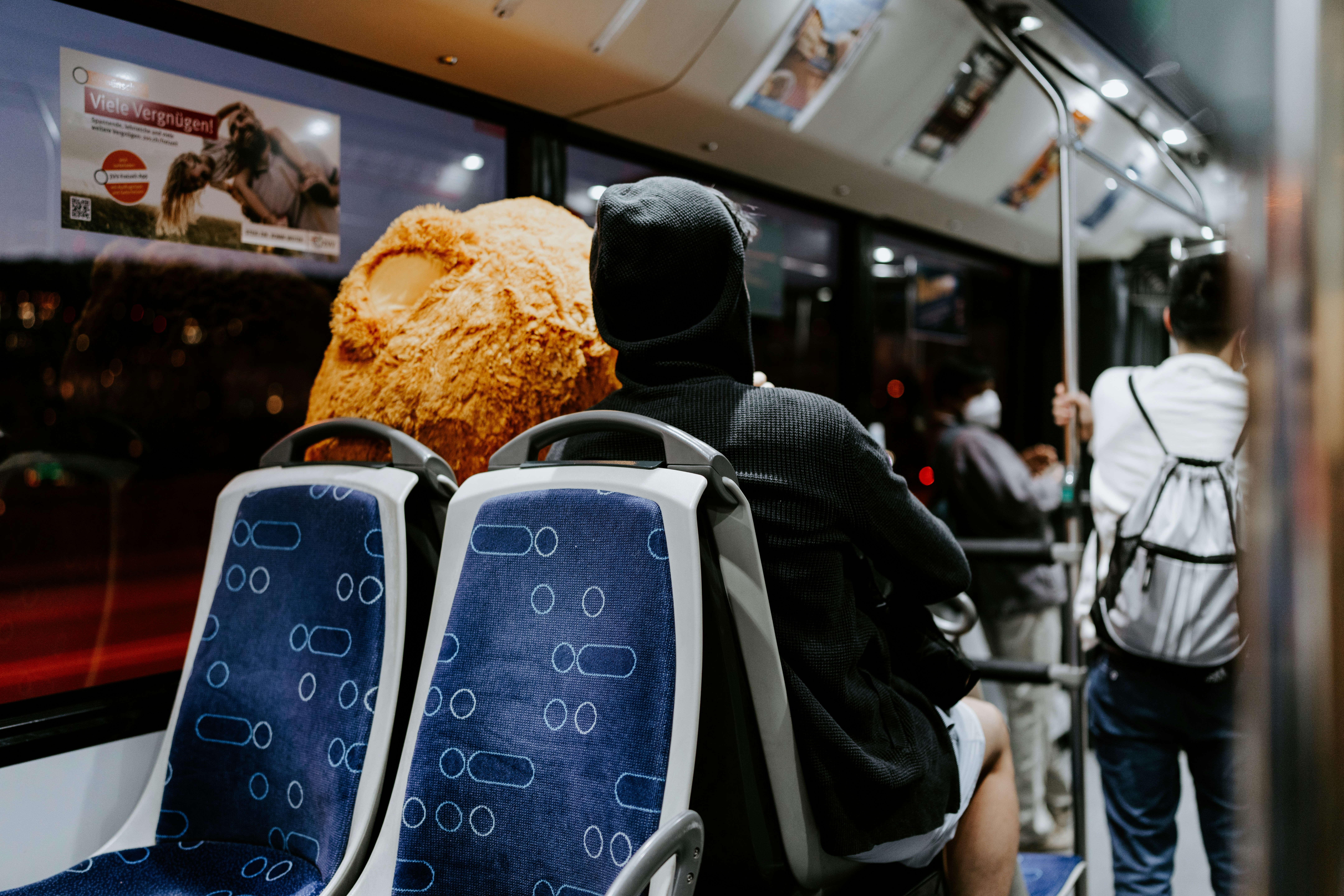 a couple of people sitting on a train next to each other, 
