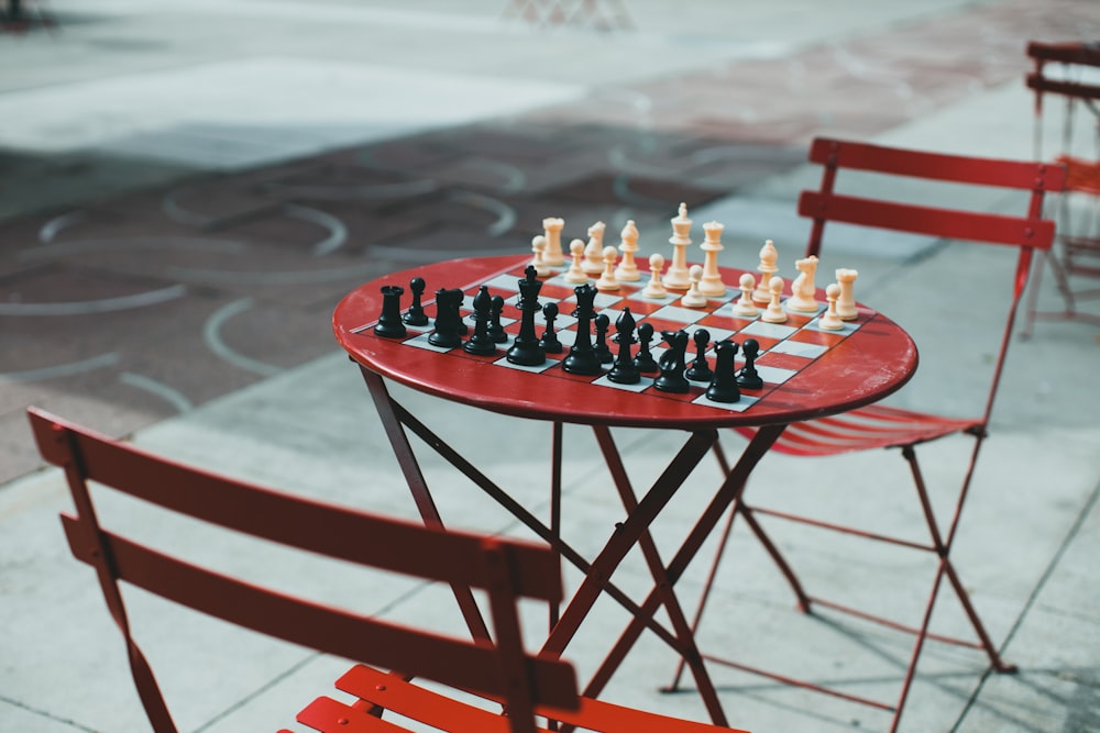 a red table with a chess set on top of it