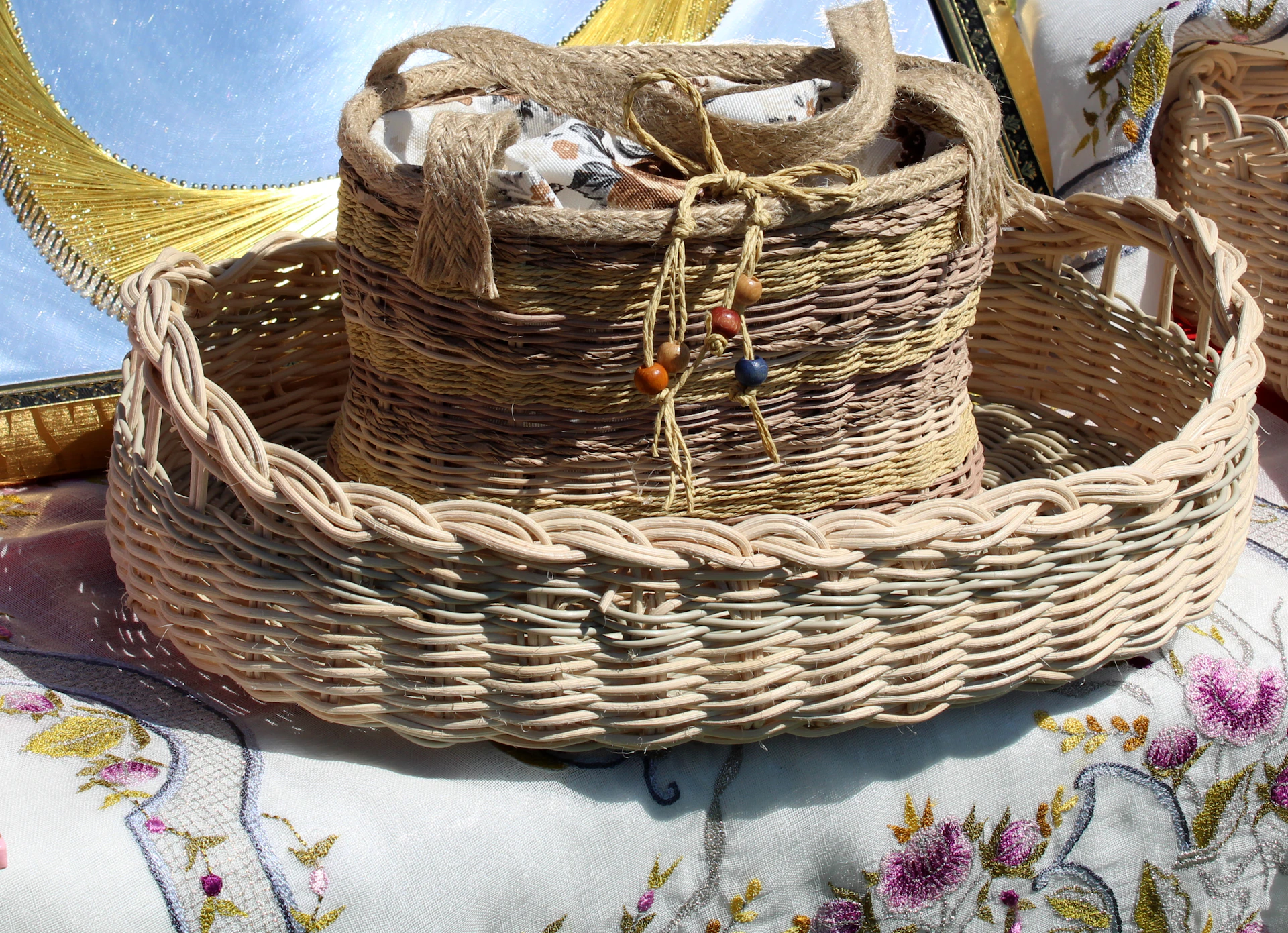 An intricate handwoven basket from the Myènè people displayed on a rustic wooden table with natural light.