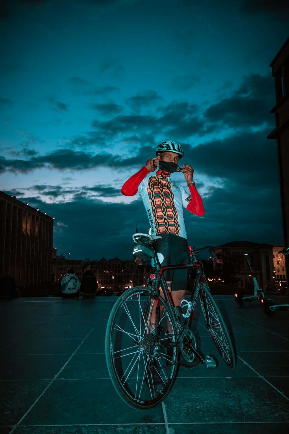 a man riding a bike with a helmet on