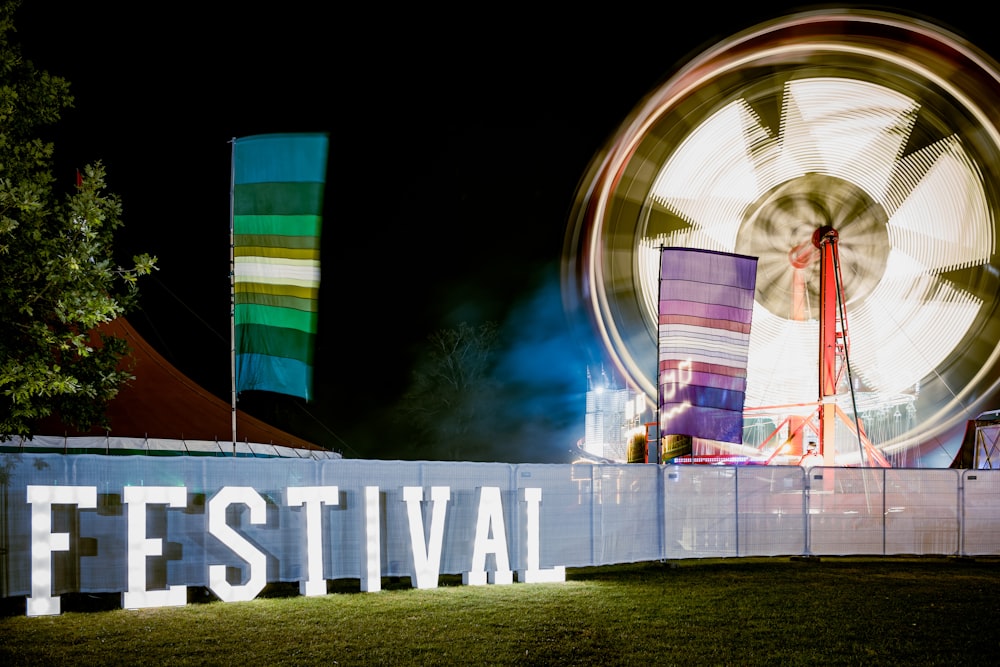 a large ferris wheel sitting in the middle of a field