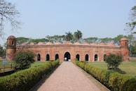 a large brick building with a walkway leading to it