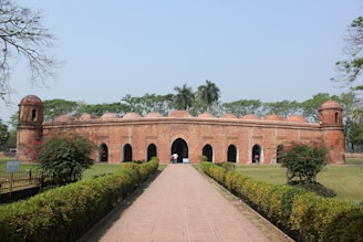 a large brick building with a walkway leading to it