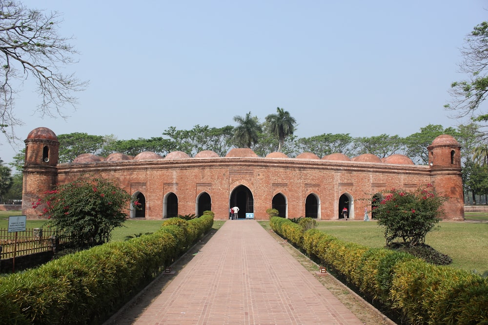 a large brick building with a walkway leading to it