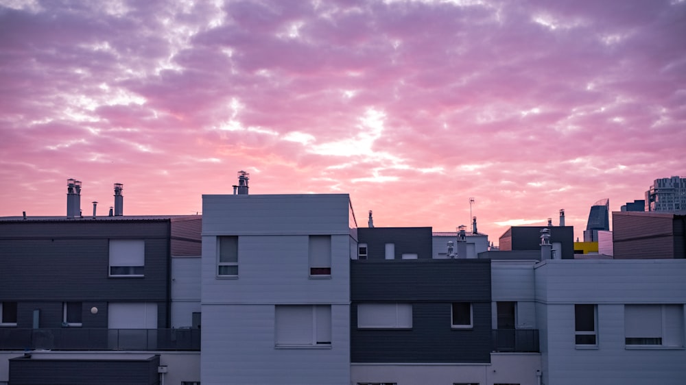 a view of a city at sunset from a rooftop